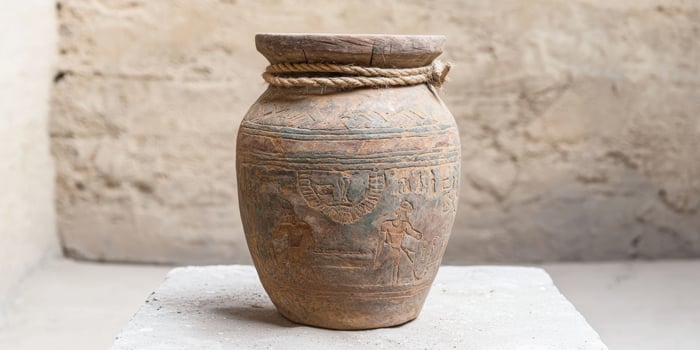Antique ceramic pot with intricate carvings photo