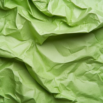Crumpled green tissue paper texture background photo