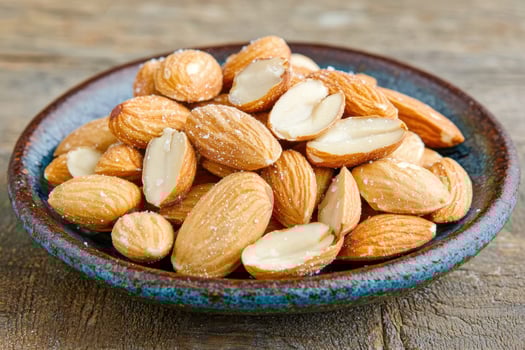 Roasted salted almonds in a rustic bowl photo