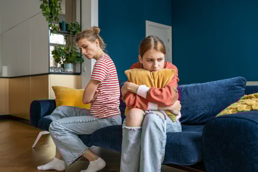 Upset frustrated mother and teenage daughter ignoring each other after quarrel at home, not talking photo