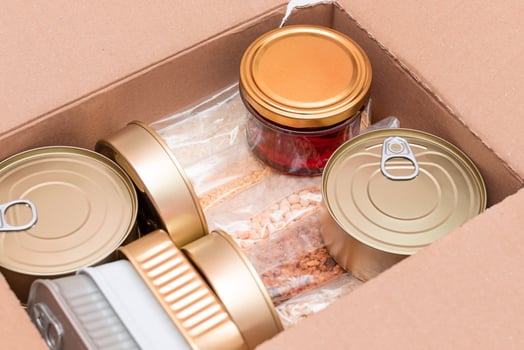 Food Reserves or Donation Box. Carton Box with Canned Food, Cereals and Grocery. Emergency Food Storage in Case of Crisis. Free Social Help, Blessings and Care. Strategic Food Supplies photo