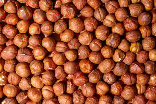 Scattered Peeled Hazelnut - Top View. Background from Hazelnuts. Natural High-Calorie Snacks photo