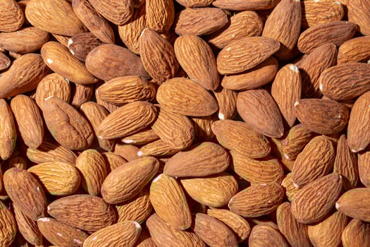 Scattered Almonds. Background from Almond Nuts. Natural High-Calorie Snacks photo