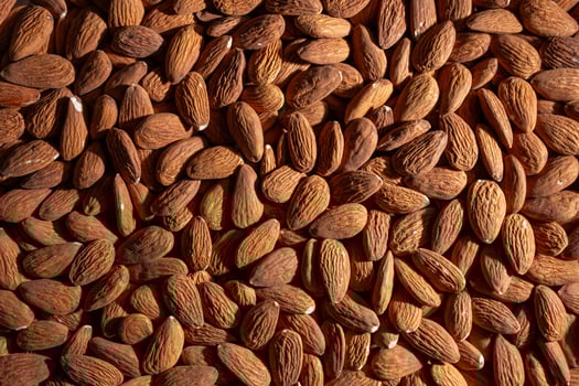 Scattered Almonds. Background from Almond Nuts. Natural High-Calorie Snacks photo