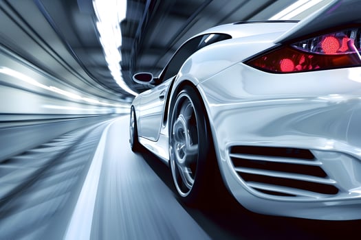 White car with sleek design speeds through tunnel on tires photo