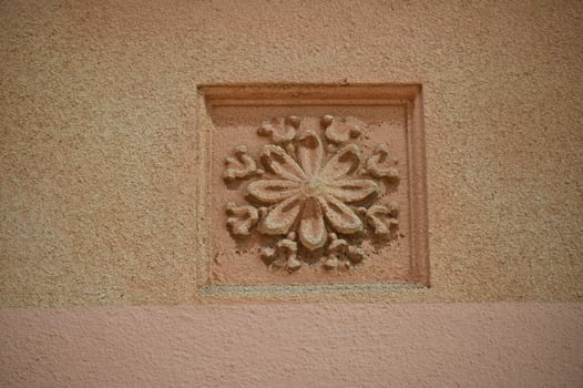 a decorative flower on a pink wall photo