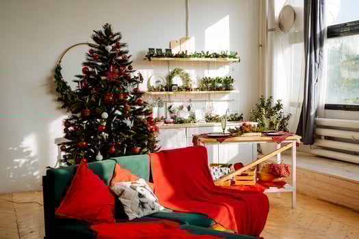 A living room with a christmas tree and a couch photo