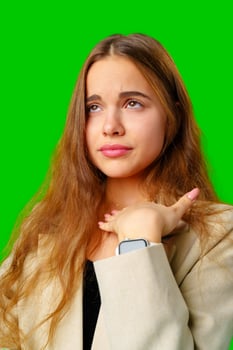 Young Woman Posing in beige Suit against green background photo