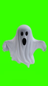 ghost in a white sheet with green background photo
