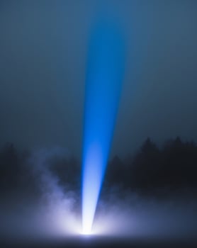 A blue light is shining through the fog photo