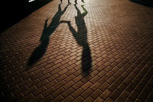 silhouette of a man and a woman, outdoors, shadows from people photo