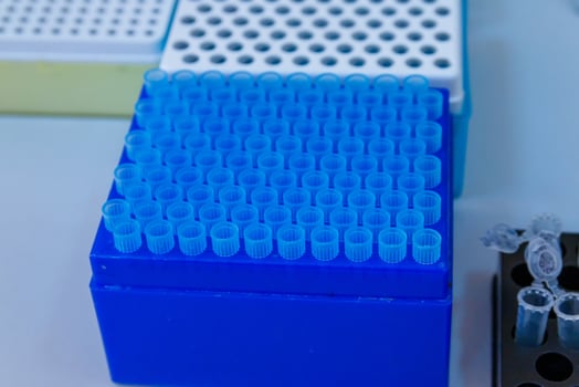 Rack with blood exa medical tubes. Empty sterile blood test tubes. photo