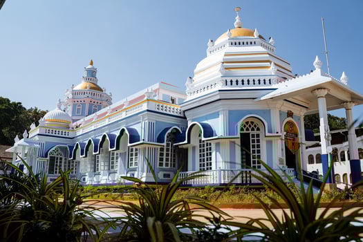 An Indian temple of blue color in clear weather. Goa pilgrim's journey through holy places. Beautiful ashram. A place of worship for the god Shiva. photo
