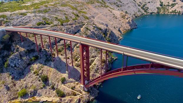 Engineering sector bridge construction. Infrastructure above the sea. Parts of the red steel arch bridge. Road viaduct Maslenica bridge, Croatia. photo