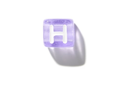 Purple translucent letter block with white h and shadow on white background capturing minimalist design photo