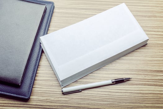 Photo of blank envelope on a wooden background