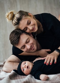 Portrait of young happy parents with newborn. Lovely family concept. photo