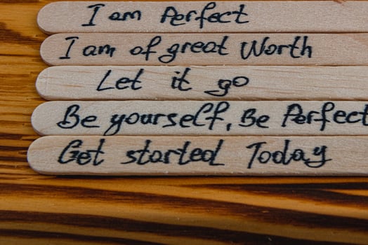 Positive thoughts to increase self esteem on wooden sticks photo