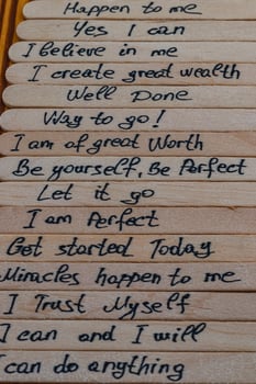 Good positive thoughts to increase self esteem are written on wooden sticks photo