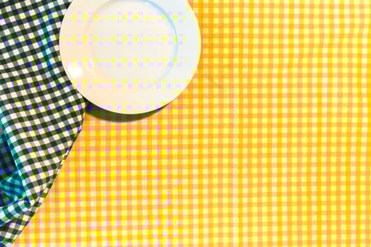 the plate on yellow checkered table cloth photo