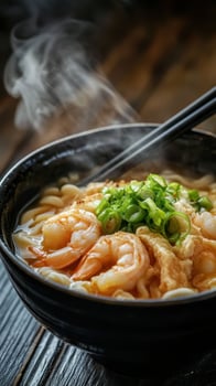 Japanese udon noodle soup with shrimps on table photo