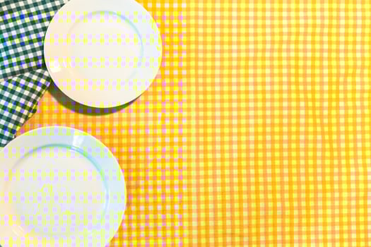 the plate on yellow checkered table cloth photo