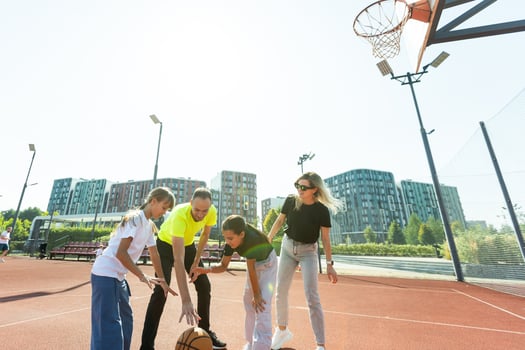 family playing basketball on court photo