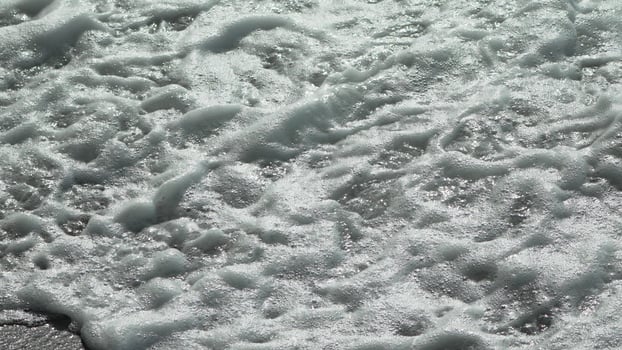 Foam Ocean Wave Closeup. White foam covering the surface of a wave in the ocean. photo