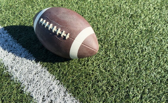 Pro American Football on the Field Close Up with Yard Lines Beyond photo