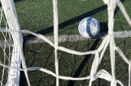 Soccer ball on a grass football field photo