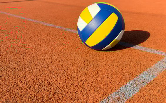 volleyball. blue with yellow color ball on the playground. volleyball cover, red. ball game photo