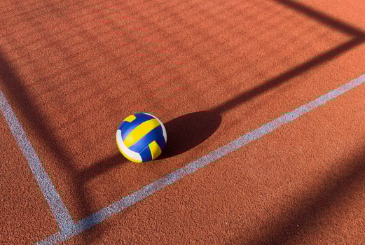 A volley ball is placed on a floor photo