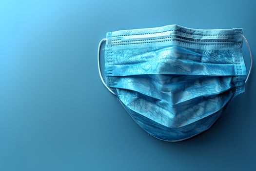 Blue Surgical Face Mask on Gradient Background for Health and Safety Themes photo