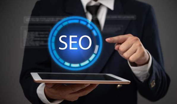 Seo business man holding tablet with seo icon photo