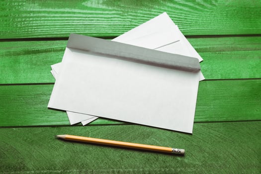 Blank paper, envelope on green wooden table photo