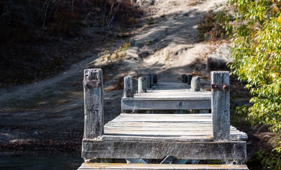 Wooden jetty bridge in the water calm clear lake Hayes New Zealand photo