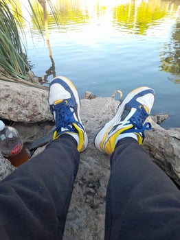 A person wearing blue and yellow sneakers photo