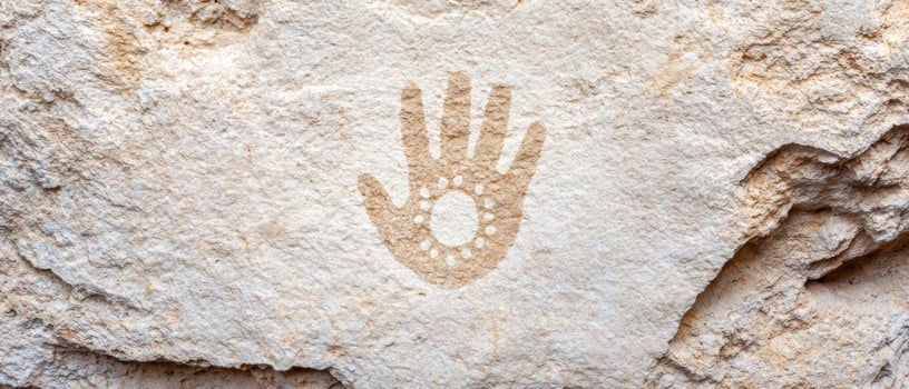 ancient rock carving of a hand symbol photo