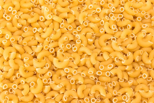 Uncooked Chifferi Rigati Pasta Background. Fat and Unhealthy Food. Classic Dry Macaroni Texture. Italian Culture and Cuisine. Raw Pasta photo
