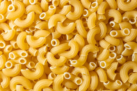 Uncooked Chifferi Rigati Pasta. A Culinary Canvas of Chifferi Rigati, Creating a Lively and Textured Background for Gourmet Cooking. Dry Pasta. Raw Macaroni - Top View, Flat Lay photo
