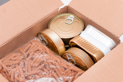 Food Reserves or Donation Box. Carton Box with Canned Food, Cereals and Grocery. Emergency Food Storage in Case of Crisis. Free Social Help, Blessings and Care. Strategic Food Supplies photo