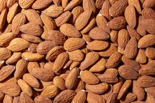 Scattered Almonds. Background from Almond Nuts. Natural High-Calorie Snacks photo
