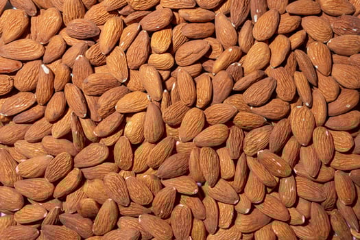 Scattered Almonds. Background from Almond Nuts. Natural High-Calorie Snacks photo