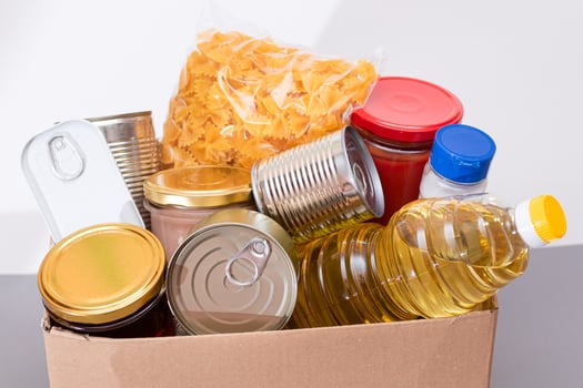 Donation Box of Free Food. Carton Box with Canned Food, Cereals and Grocery. Meal Reserves. Emergency Food Storage in Case of Crisis. Free Social Help, Blessings and Care. Strategic Food Supplies photo