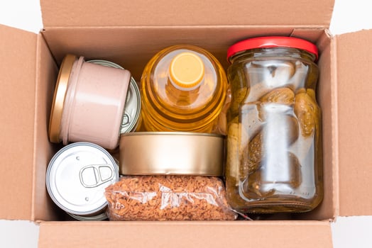Food Reserves or Donation Box. Carton Box with Canned Food, Cereals and Grocery. Emergency Food Storage in Case of Crisis. Free Social Help, Blessings and Care. Strategic Food Supplies photo