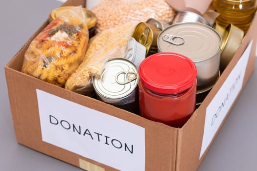 Donation Box of Free Food. Carton Box with Canned Food, Cereals and Grocery. Meal Reserves. Emergency Food Storage in Case of Crisis. Free Social Help, Blessings and Care. Strategic Food Supplies photo