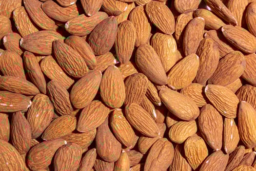 Scattered Almonds. Background from Almond Nuts. Natural High-Calorie Snacks photo
