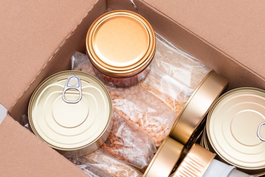 Food Reserves or Donation Box. Carton Box with Canned Food, Cereals and Grocery. Emergency Food Storage in Case of Crisis. Free Social Help, Blessings and Care. Strategic Food Supplies photo