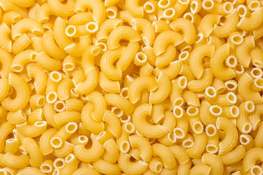 Uncooked Chifferi Rigati Pasta. A Culinary Canvas of Chifferi Rigati, Creating a Lively and Textured Background for Gourmet Cooking. Dry Pasta. Raw Macaroni - Top View, Flat Lay photo