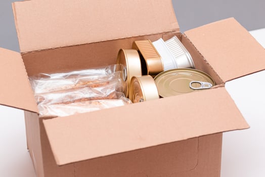 Food Reserves or Donation Box. Carton Box with Canned Food, Cereals and Grocery. Emergency Food Storage in Case of Crisis. Free Social Help, Blessings and Care. Strategic Food Supplies photo